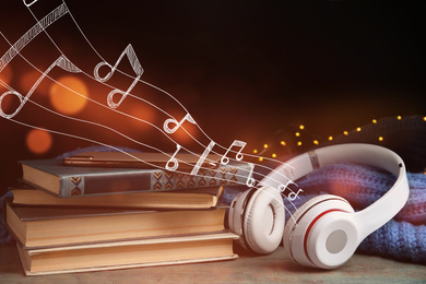 Books, headphones and mobile phone on wooden table 