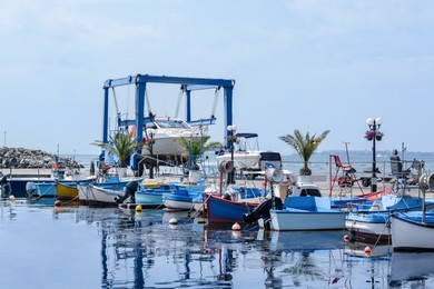 Beautiful view of city pier with moored boats on sunny day