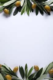 Frame made of fresh green olives and leaves on white background, flat lay. Space for text