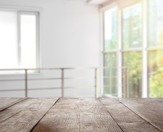 Empty wooden surface and blurred view of modern window 