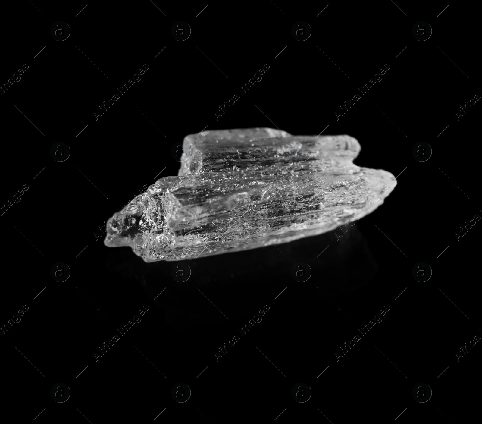 Photo of Menthol crystals on black background, closeup view