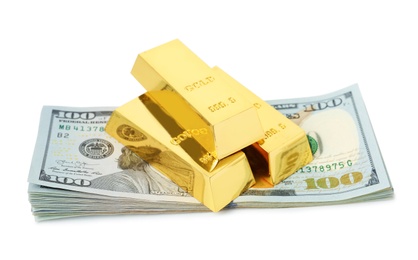 Shiny gold bars and dollar bills on white background