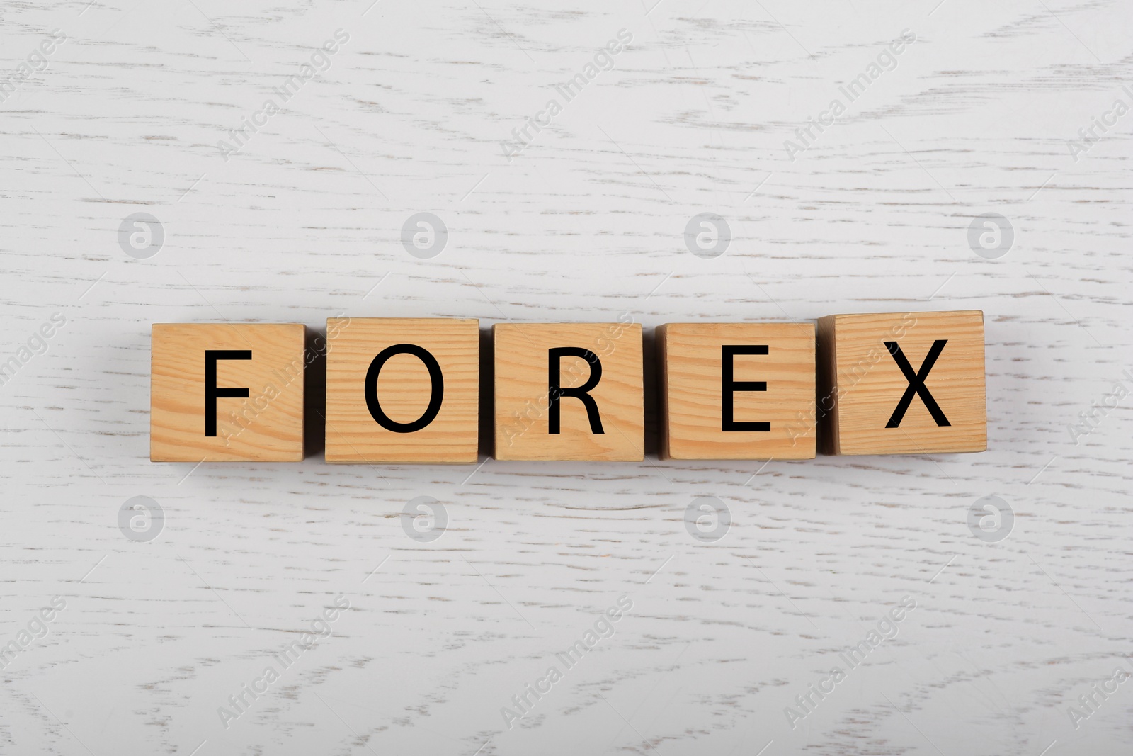 Photo of Word Forex with cubes on white wooden table, top view