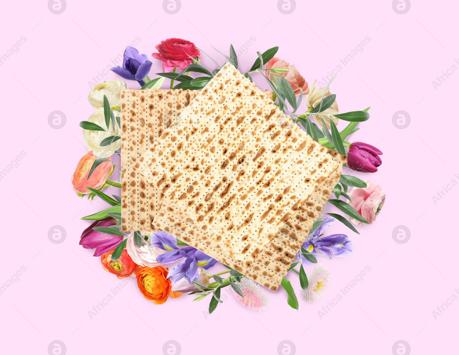 Image of Tasty matzos and flowers on pink background, flat lay. Passover (Pesach) celebration