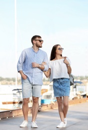 Young hipster couple in jean clothes on pier