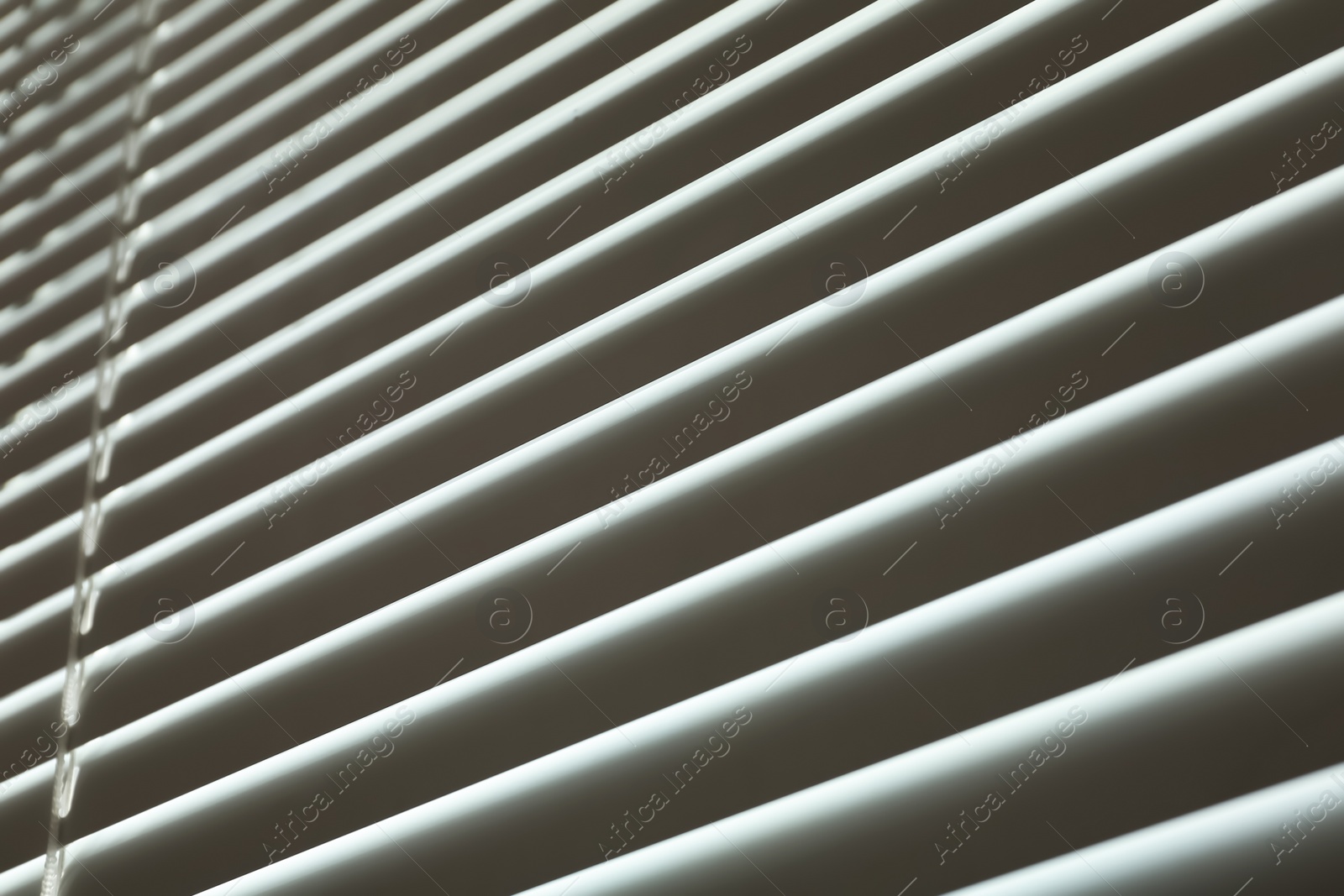 Photo of Closed modern white window blinds, low angle view