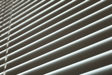 Closed modern white window blinds, low angle view