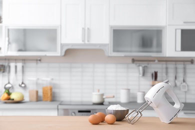 Photo of Products, mixer and blurred view of kitchen interior on background