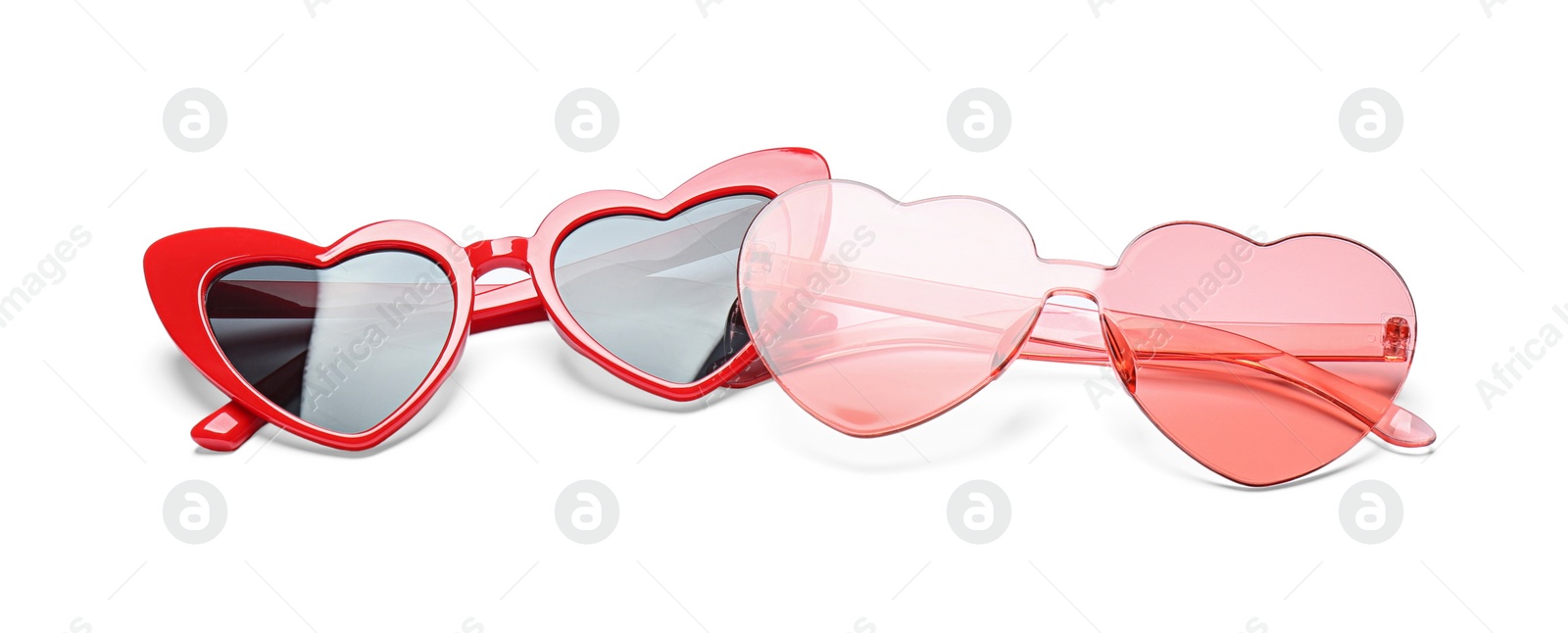 Photo of Different stylish heart shaped glasses on white background