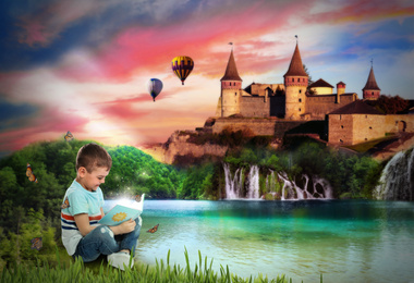 Cute little boy reading magic book near lake and beautiful castle on background