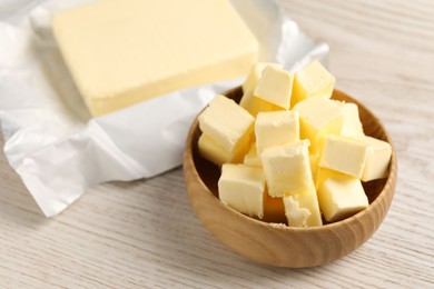 Photo of Tasty butter on light wooden table, closeup