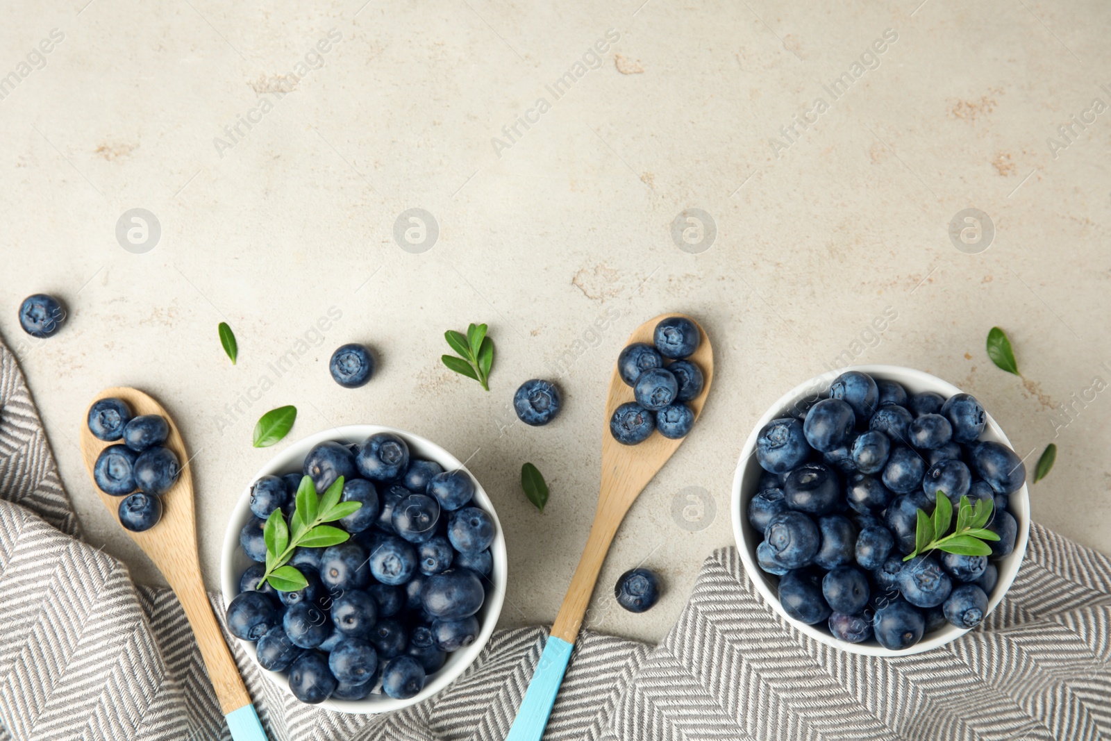 Photo of Flat lay composition with tasty blueberries on light table, space for text