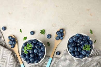 Flat lay composition with tasty blueberries on light table, space for text