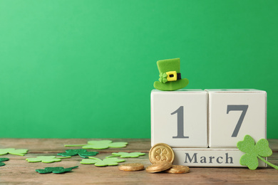 Photo of Composition with block calendar on wooden table, space for text. St. Patrick's Day celebration