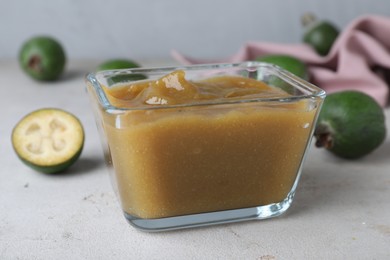 Feijoa jam on light grey table, closeup