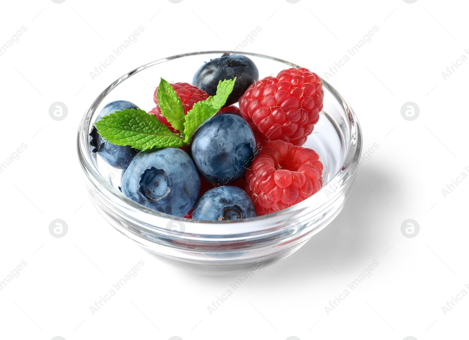 Photo of Bowl with raspberries and blueberries on white background