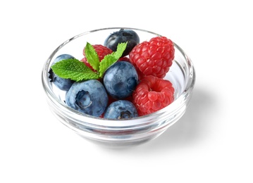 Photo of Bowl with raspberries and blueberries on white background