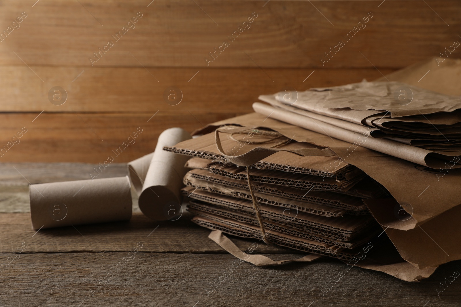 Photo of Different waste paper on wooden table, closeup