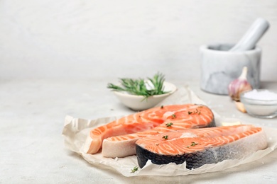 Fresh raw salmon steaks on table