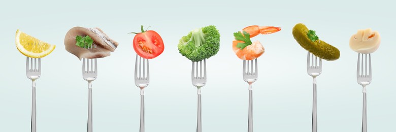 Image of Forks with different food products on light grey background, collection