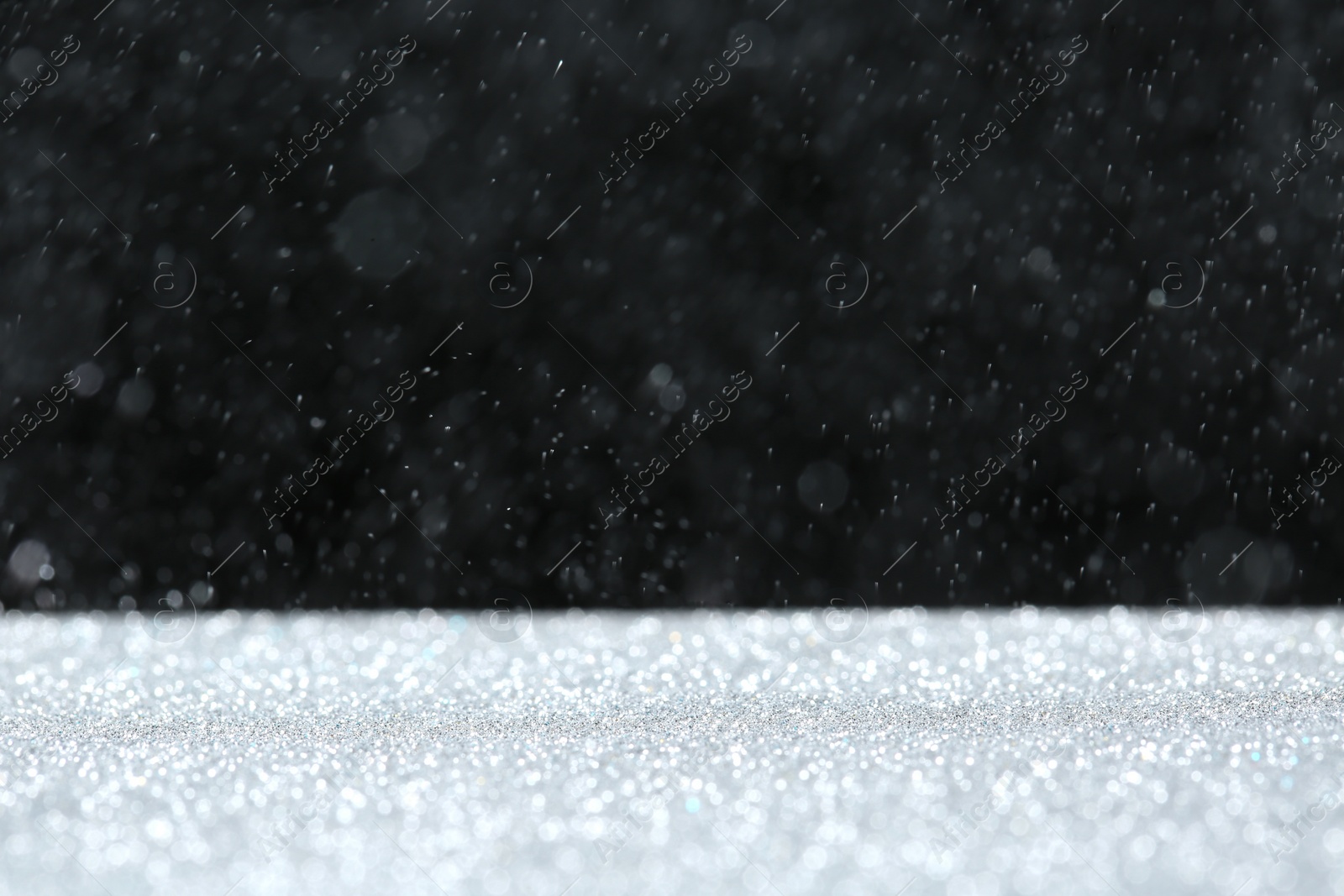 Photo of Glitter on table against dark background, space for text. Bokeh effect