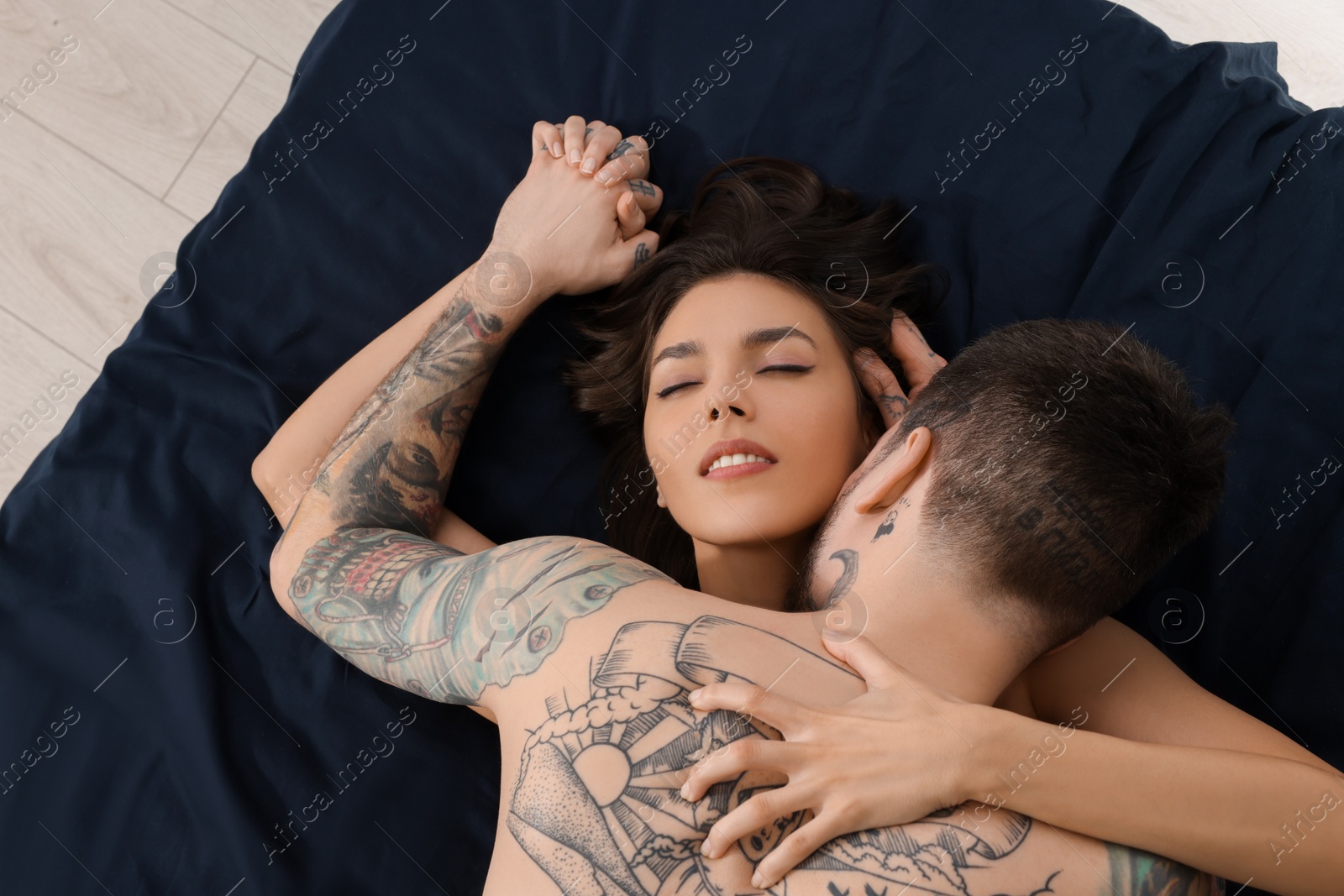 Photo of Passionate couple having sex on bed, top view