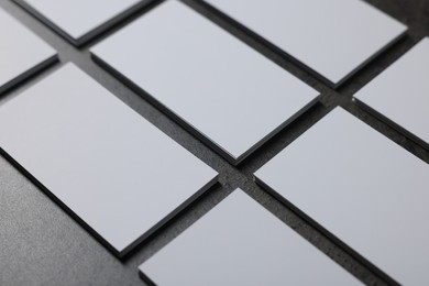 Photo of Blank business cards on grey textured table, closeup. Mockup for design