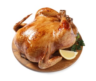 Photo of Tasty roasted chicken with parsley and lemon isolated on white