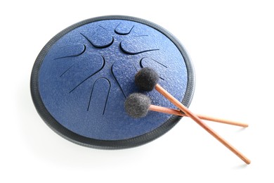 Photo of Steel tongue drum with soft mallets on white background. Percussion musical instrument