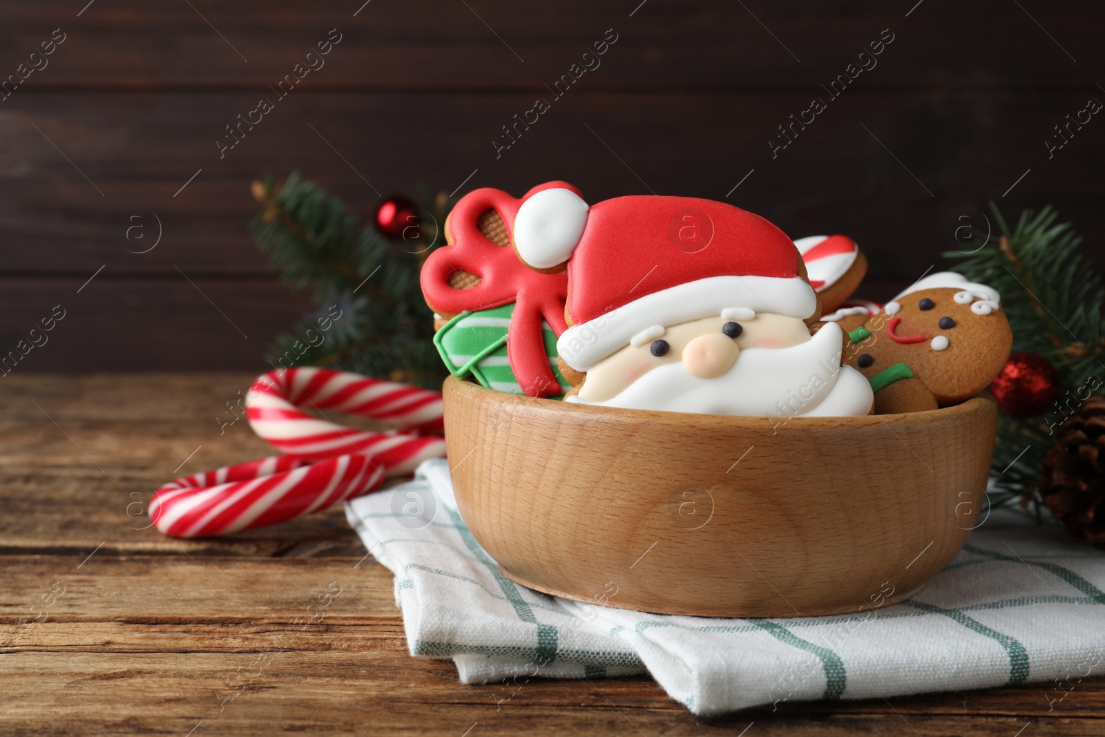 Photo of Tasty Christmas cookies and candy canes on wooden table