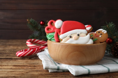 Tasty Christmas cookies and candy canes on wooden table