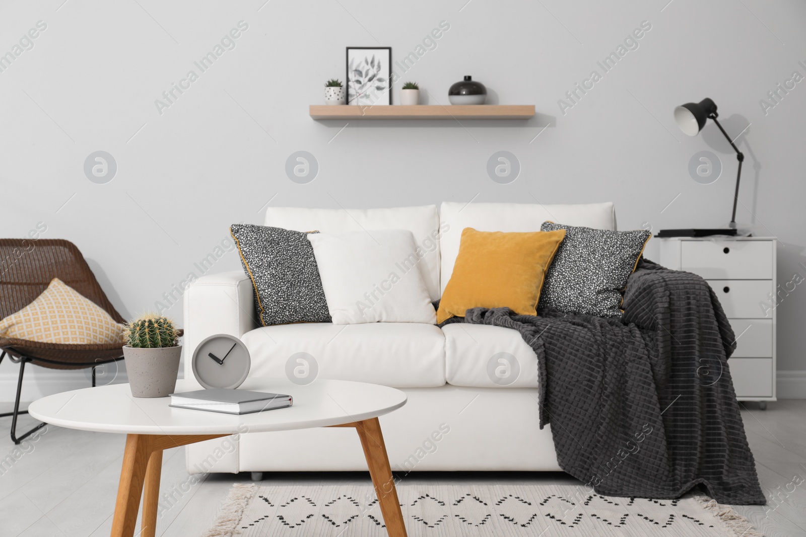 Photo of Elegant white sofa in modern living room interior