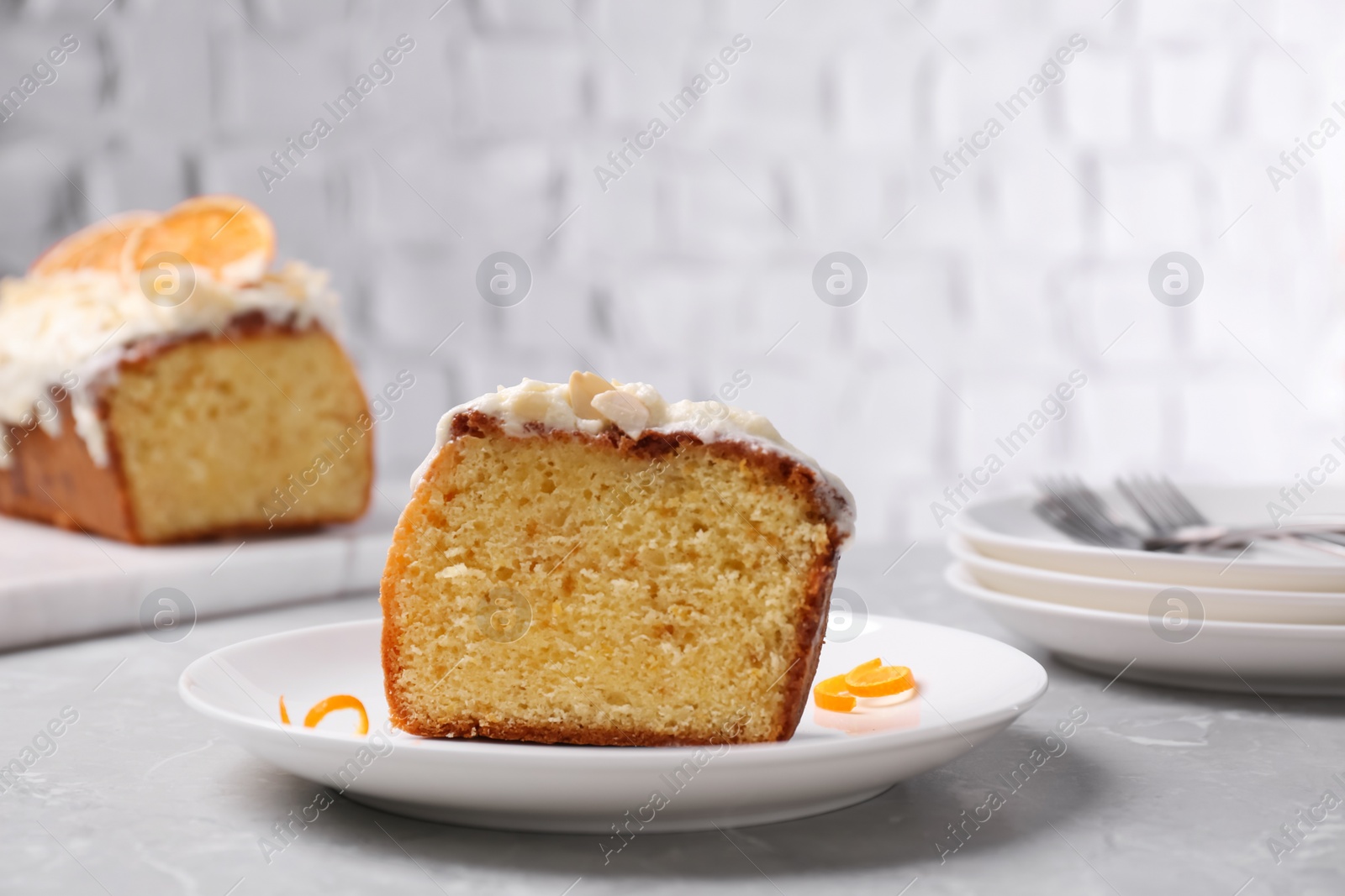 Photo of Cut delicious sweet cake on light grey marble table
