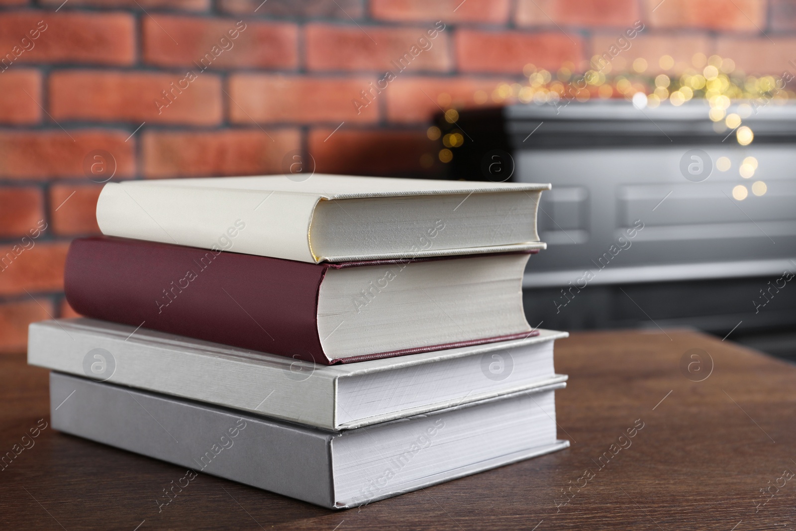 Photo of Stack of hardcover books on wooden table indoors