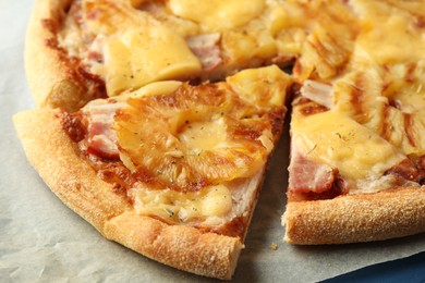Photo of Delicious cut pineapple pizza on table, closeup