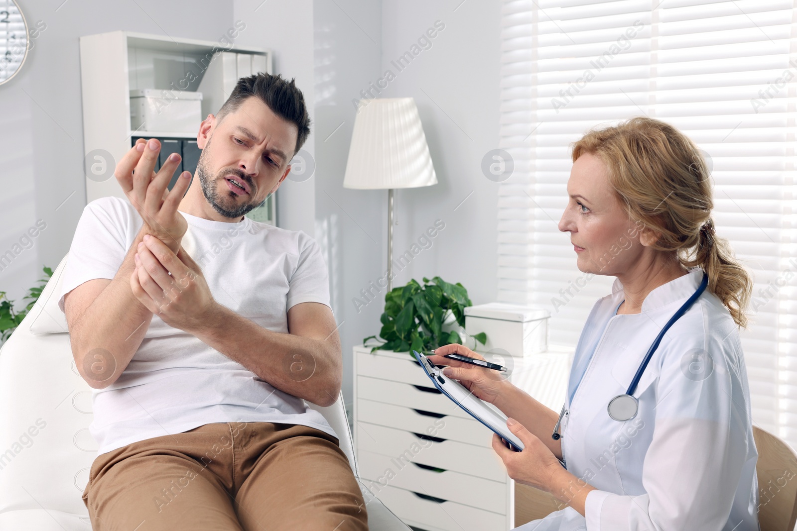 Photo of Doctor listening to patient's complaints during consultation in clinic