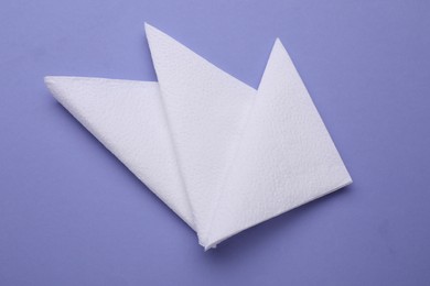 Photo of Clean paper tissues on violet background, top view