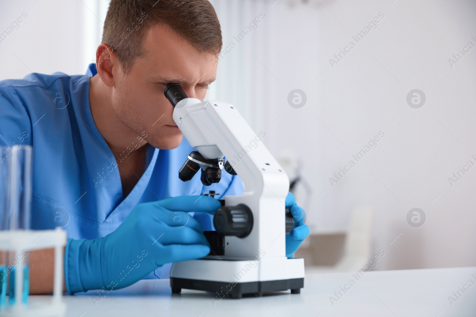 Photo of Scientist using modern microscope at table, closeup. Medical research
