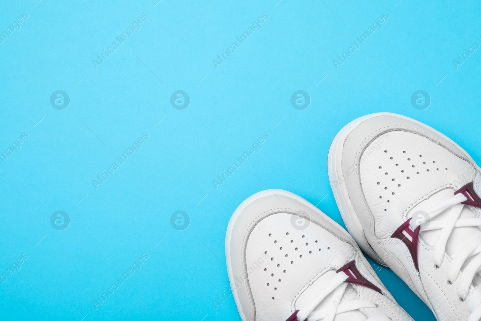 Photo of Pair of stylish shoes on blue background, top view. Space for text