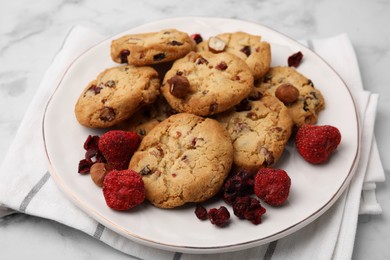 Photo of Cookies with freeze dried fruits and nuts on white marble table, closeup