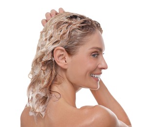 Beautiful happy woman washing hair on white background