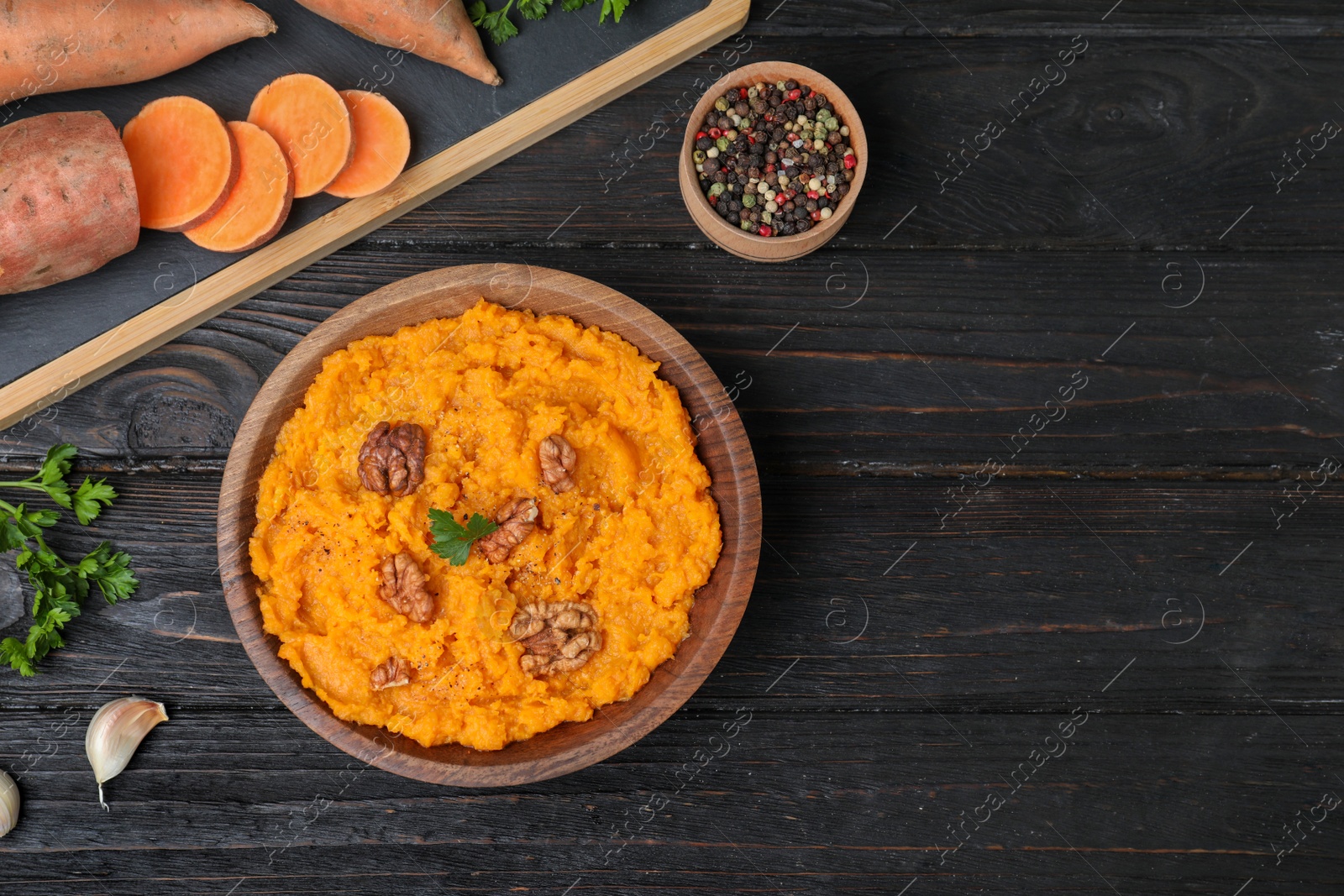 Photo of Flat lay composition with mashed sweet potatoes on wooden background, space for text