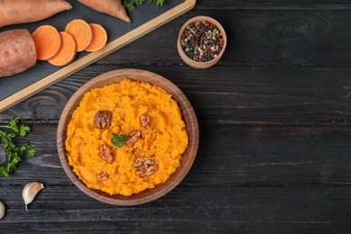 Photo of Flat lay composition with mashed sweet potatoes on wooden background, space for text