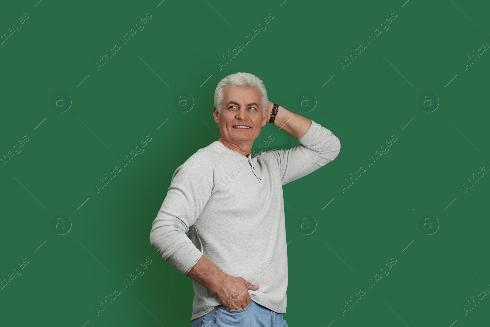 Photo of Portrait of handsome mature man on color background