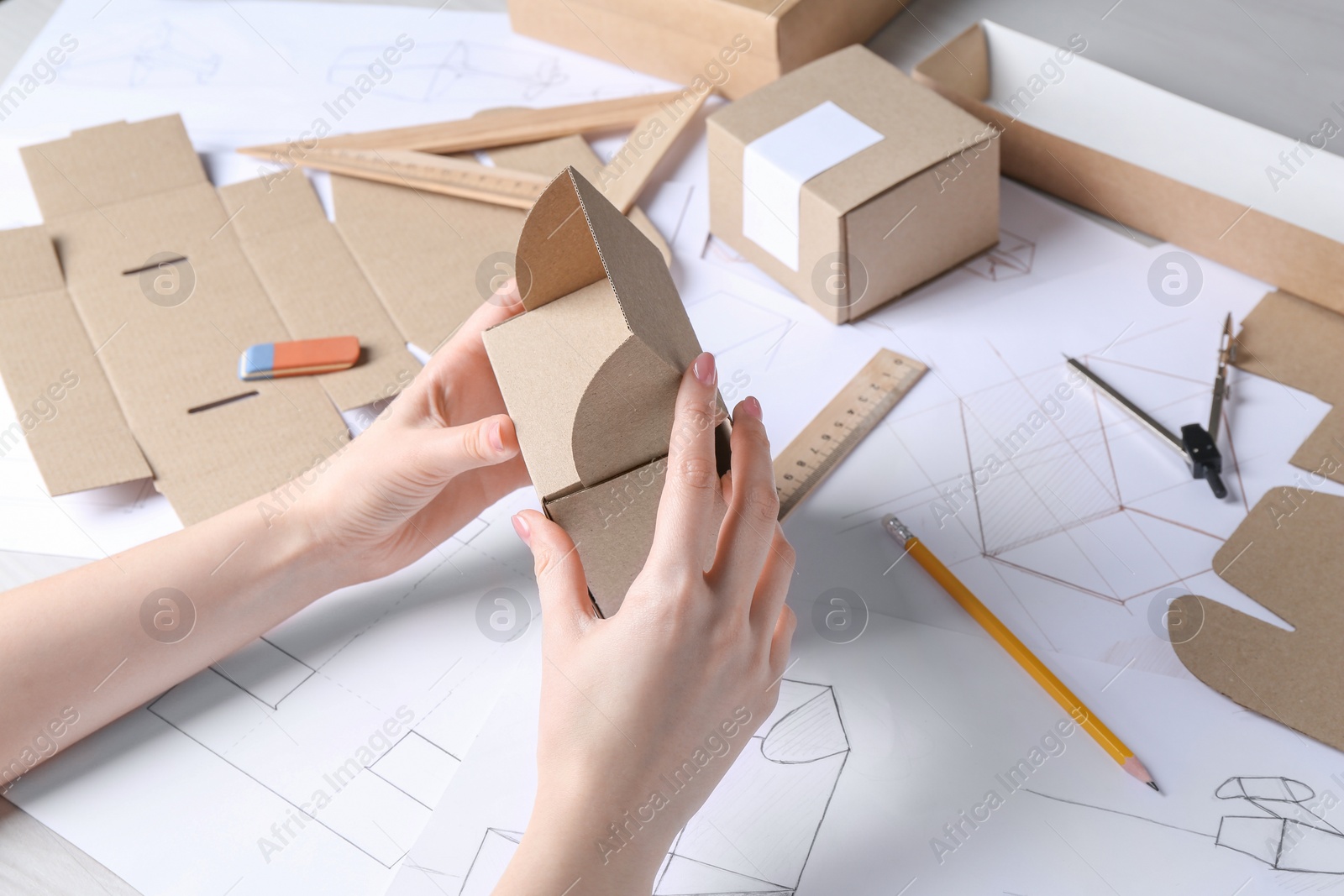 Photo of Woman creating packaging design at table, closeup