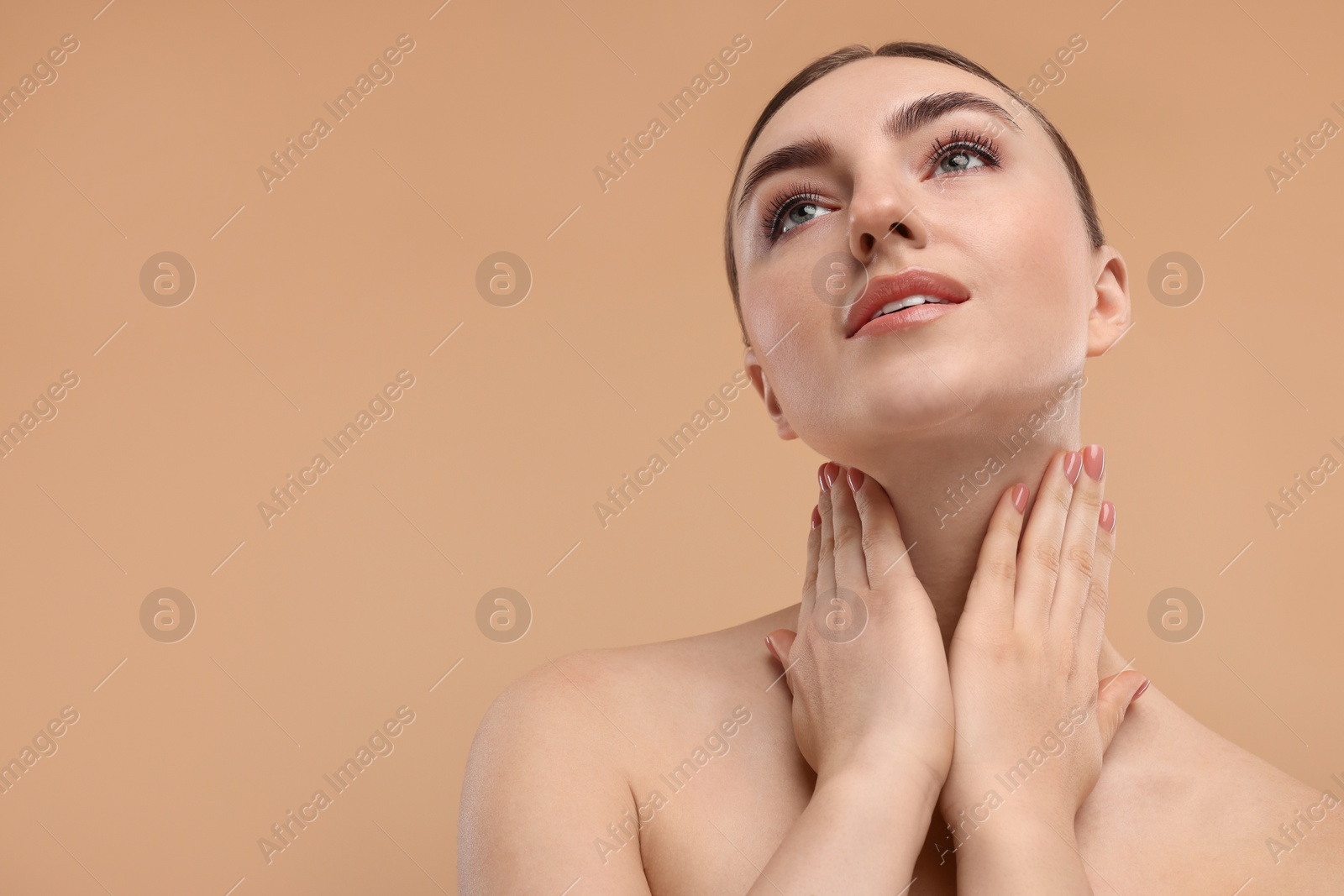 Photo of Beautiful woman touching her neck on beige background. Space for text