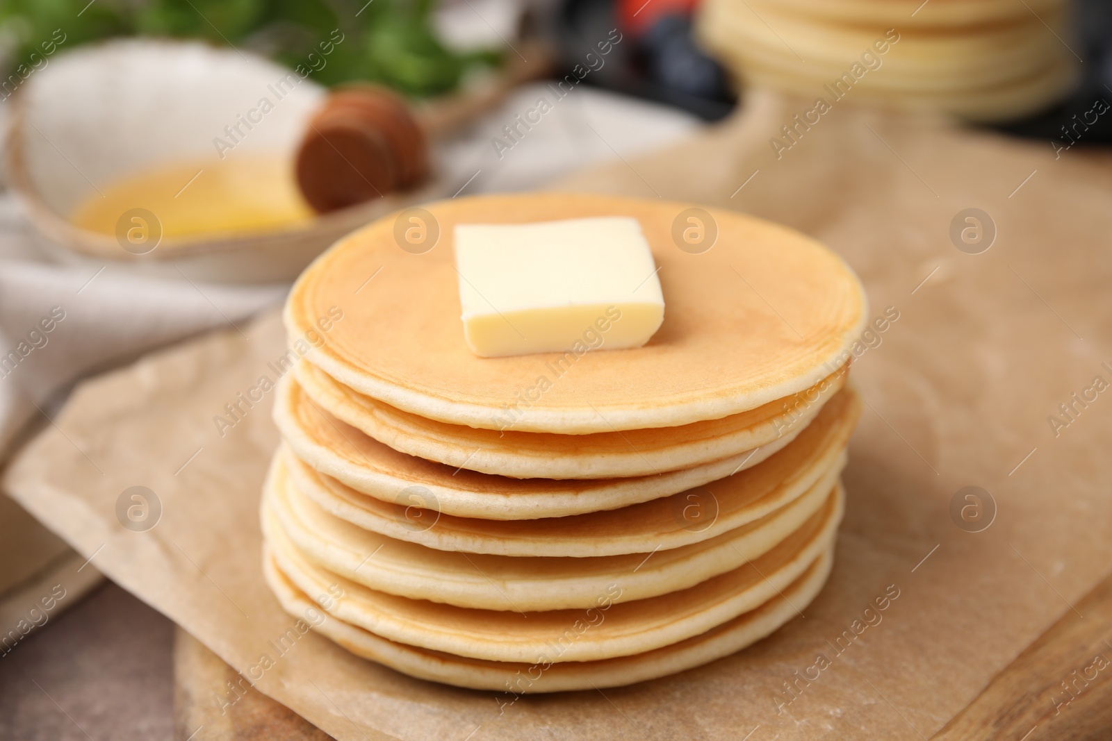 Photo of Delicious pancakes with butter on table, closeup