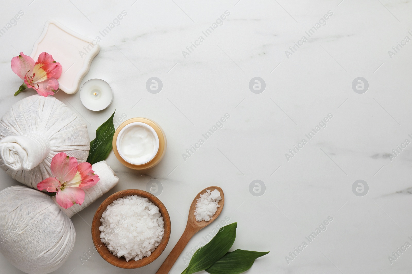 Photo of Flat lay composition with spa products and flowers on white marble table. Space for text