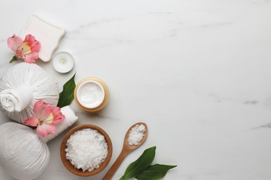 Photo of Flat lay composition with spa products and flowers on white marble table. Space for text