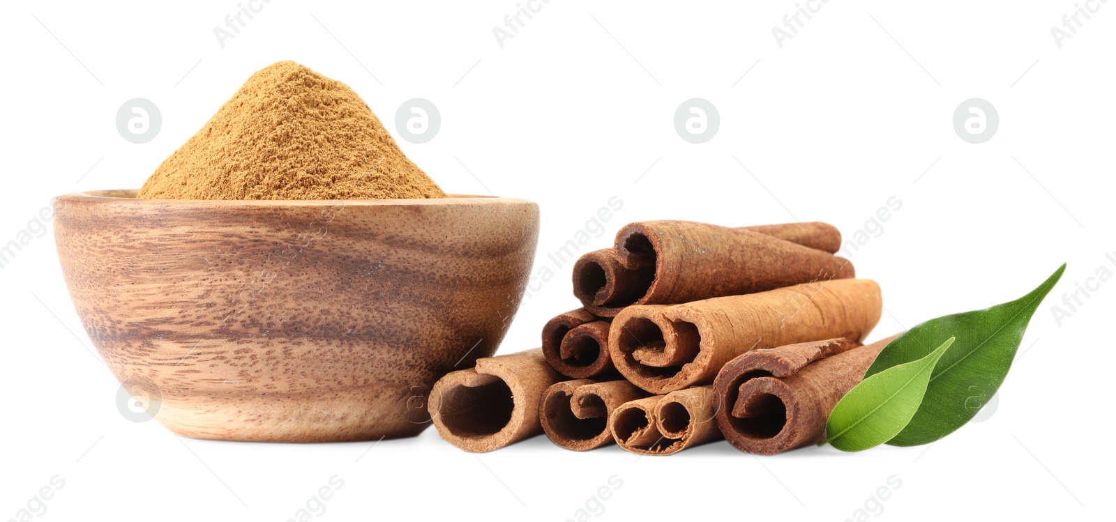 Photo of Dry aromatic cinnamon sticks, powder and green leaves isolated on white